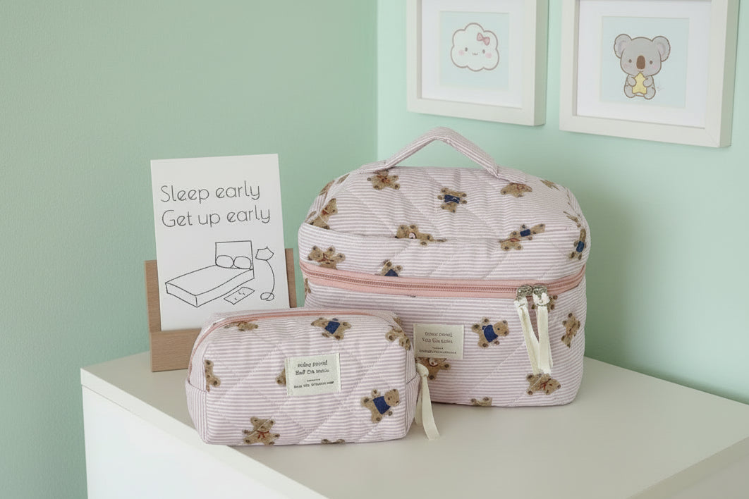 mint green walls with 2 pictures and a wooden photo stand with striped bags with teddy bears