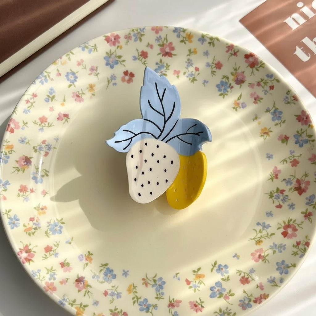 strawberry hair claw clip on a ditsy floral plate 